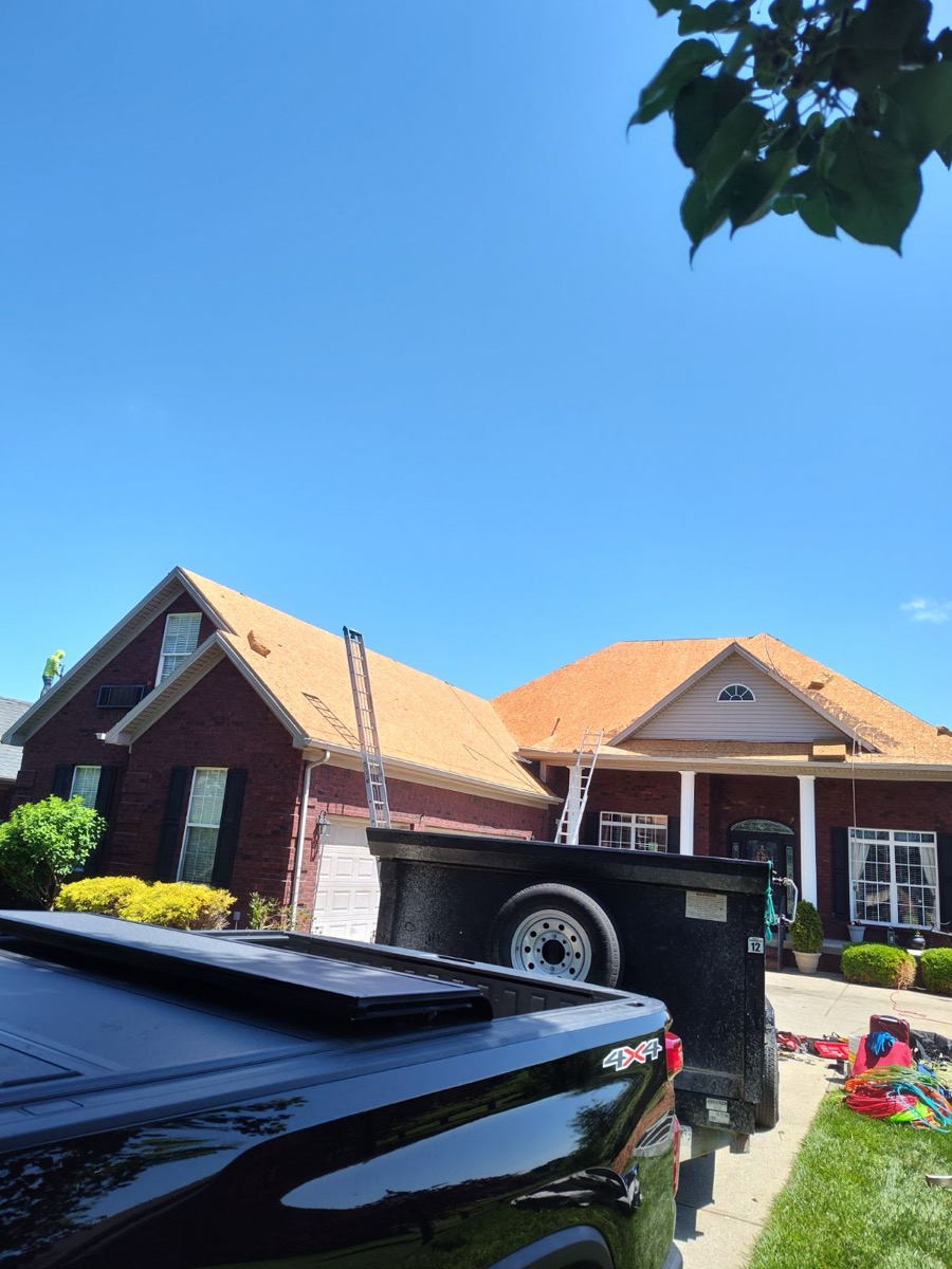 Roof replacement in progress on a brick home in Cincinnati